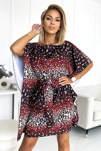 A stylish dress featuring a bold leopard print pattern in shades of red, black, and beige, with a loose, flowing fit and a tie at the waist. The design includes short, wide sleeves and a knee-length hem, perfect for a chic and modern look.}