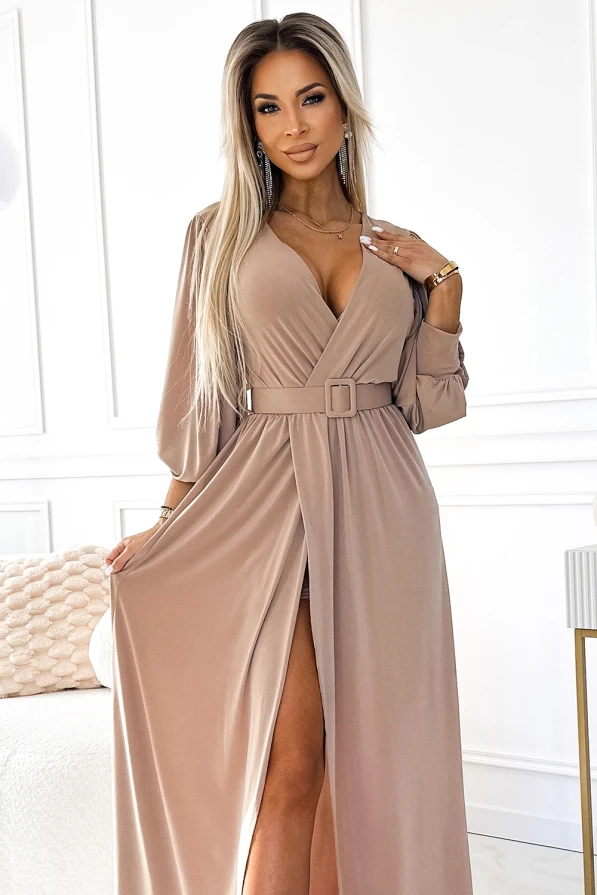 Elegant long beige dress with a deep V-neckline and a stylish belt accentuating the waist. The dress features a high slit, adding a touch of sophistication and allure.