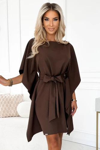 A woman is wearing an elegant brown dress with a butterfly sleeve design and a matching waist tie. The dress features a flowing silhouette, perfect for both casual and formal occasions.}