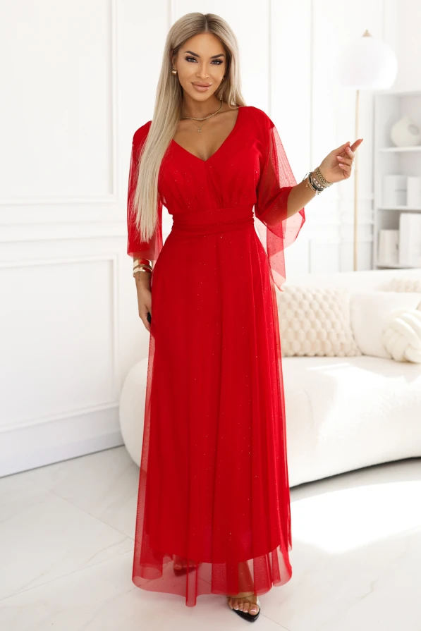 Long red maxi gown with a subtle glitter shimmer, wrap neckline and sheer three-quarter sleeves. An elegant evening dress that beautifully accentuates the waist, perfect for weddings, balls and special occasions.
