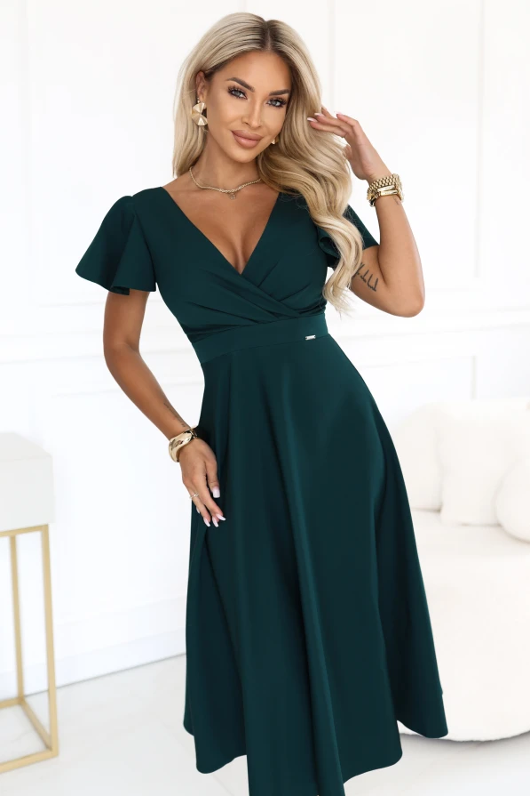 Model wearing an elegant flared midi dress in bottle green, with a wrap neckline and short sleeves.