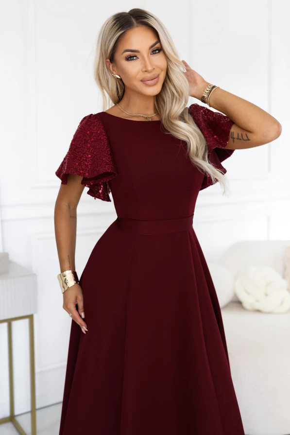 Burgundy long evening dress Mirella Numoco with sequin sleeves, a flared hem and an accentuated waist