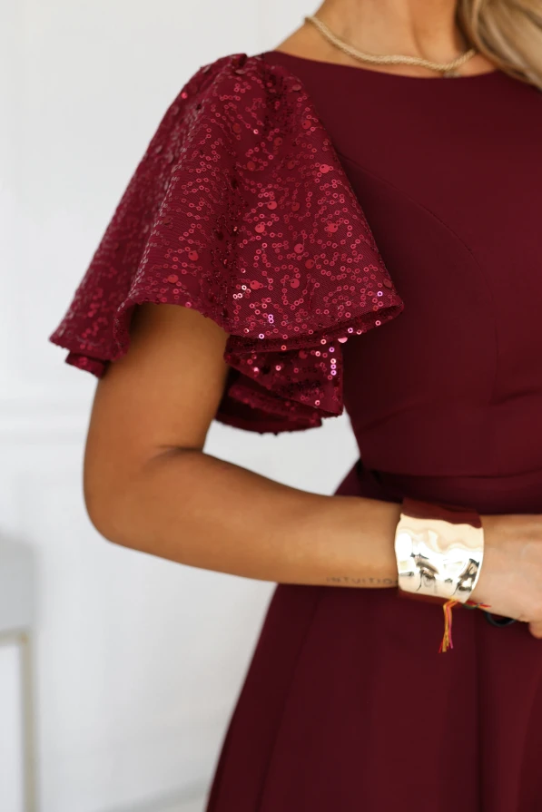 Burgundy long evening dress Mirella Numoco with sequin sleeves, a flared hem and an accentuated waist