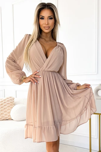 A chiffon dress in a soft beige hue features a flattering wrap design with long, sheer sleeves and a flowy skirt. The dress exudes elegance and is perfect for both casual and formal occasions.}