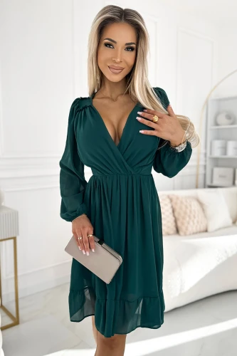A chic chiffon dress in a deep green hue features a flattering V-neckline and long sleeves, perfect for elegant occasions. The dress is complemented by a subtle ruffle hem and a cinched waist, adding a touch of sophistication.}