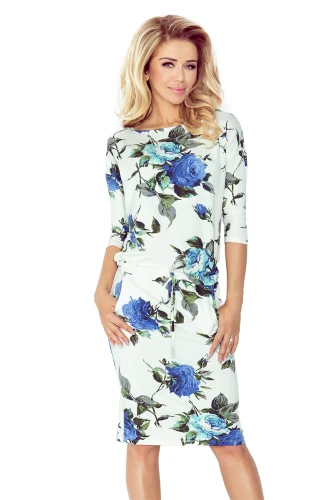 A stylish ecru sports dress featuring a vibrant blue floral pattern, perfect for casual outings. The dress has a comfortable fit with three-quarter sleeves and a drawstring waist for added style.}