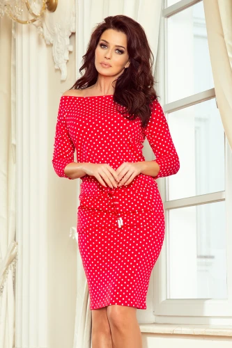 A red, off-the-shoulder dress with white polka dots features a fitted silhouette and three-quarter sleeves. The dress is accented with a drawstring waist, adding a casual yet stylish touch.}